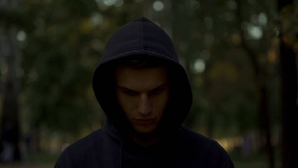 istock Upset man in hood looking down, feeling guilty and regretting criminal past 1137646571