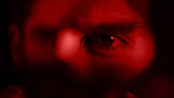 istock Man looking through magnifying glass closeup, criminal expert analyze, search 1137647279