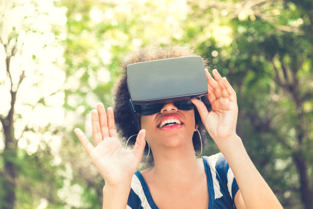 istock Afro woman enjoying watching  3D simulation video from virtual reality (VR) glasses 1137648349