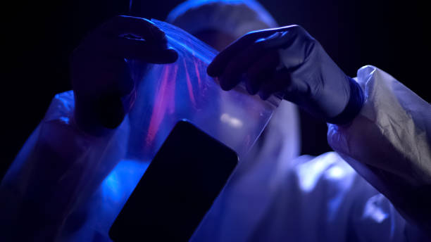 Criminal expert putting smartphone with criminal fingerprints in plastic bag Criminal expert putting smartphone with criminal fingerprints in plastic bag evidence bag stock pictures, royalty-free photos & images