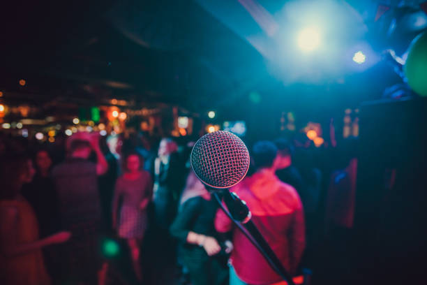 istock Public performance on stage Microphone on stage against a background of auditorium. Shallow depth of field. Public performance on stage. 1137648472