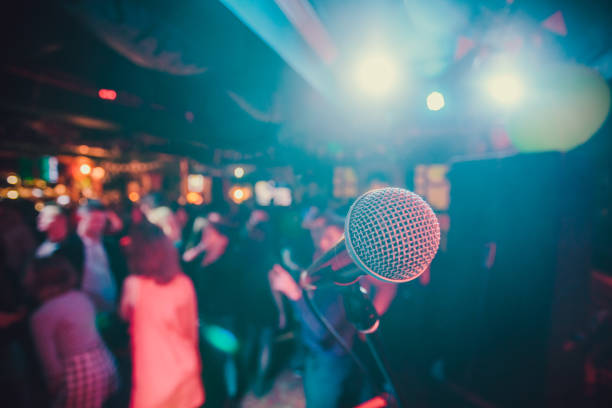 istock Public performance on stage Microphone on stage against a background of auditorium. Shallow depth of field. Public performance on stage. 1137648485