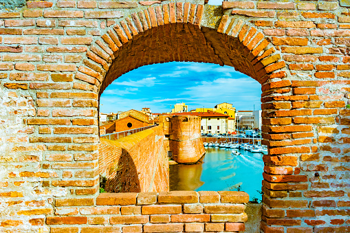 View of the landmark Fortezza Vecchia, an old fortress with a tower located in Livorno, Tuscany, Italy.