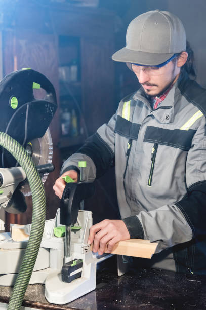 istock A young carpenter installs a wooden workpiece in a circular sawing machine. Home workshop. Novice businessman 1137650666