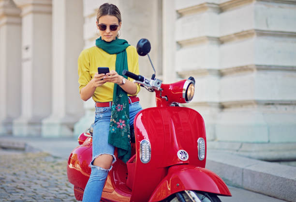 istock Young girl is texting on her motorcycle 1137653558