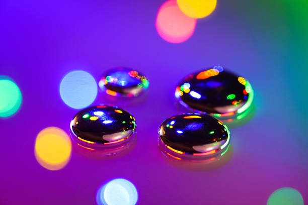 Metallic Liquid Silver Gallium Abstract Art Bokeh - Quicksilver element gallium with colorful vibrant light reflections macrophotography with selective focus and soft bokeh.