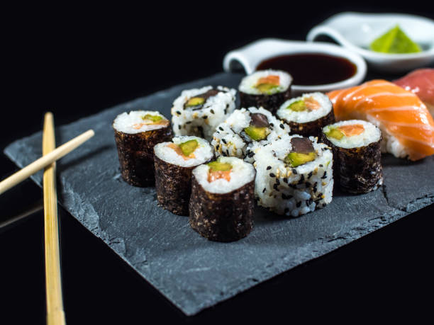 istock Sushi Set on Slate with Sushi Rolls and Wasabi on Black Background 1137664244