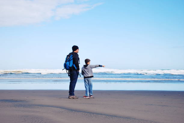 istock Man and Boy Look Out to Sea 1137672779