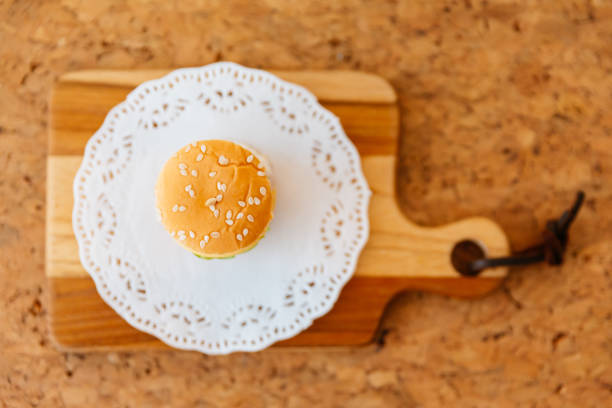 Top view of Mini Chicken Burger on wooden chopping board.