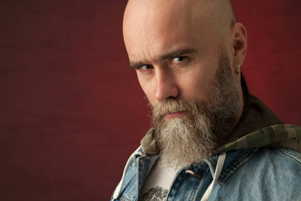 istock Studio portrait of a 40 year old bearded man on a red background 1137682678