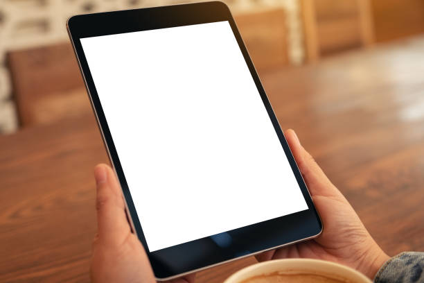 istock tablet pc with blank white screen horizontally with coffee cup on wooden table 1137684185