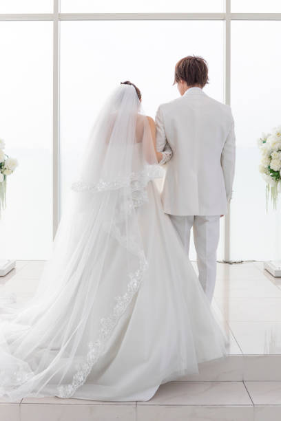 Wedding Groom and bride's back view Wedding Groom and bride's back view wedding ceremony formalwear people clothing stock pictures, royalty-free photos & images