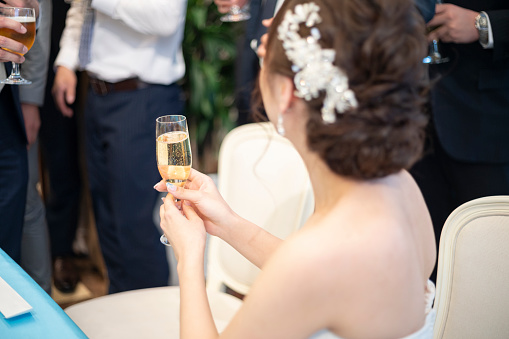 Back view of bride toasting wedding