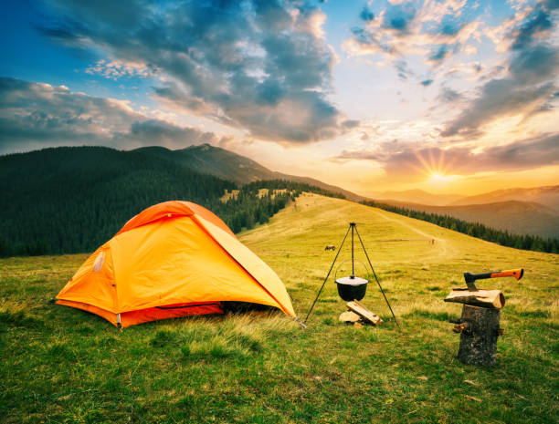 istock Tourist camp in mountains with tent and cauldron over fire at sunset 1137688157