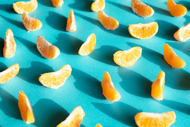 istock Pieces of peeled tangerine on a blue background 1137689632