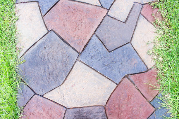 istock Top view colorful stone walkway background with grass 1137692583