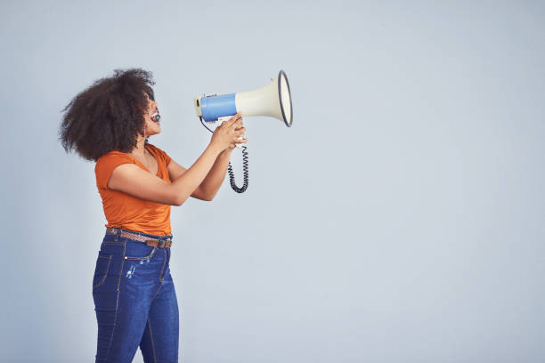 Take a stand for every woman out there Studio shot of a young woman using a megaphone against a gray background assertiveness stock pictures, royalty-free photos & images