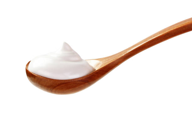 istock cream sour in a spoon isolated white backround 1137697454