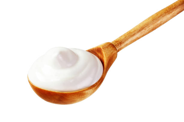 istock cream sour in a spoon isolated white backround 1137697542