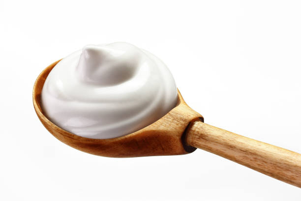 istock cream sour in a spoon isolated white backround 1137697583