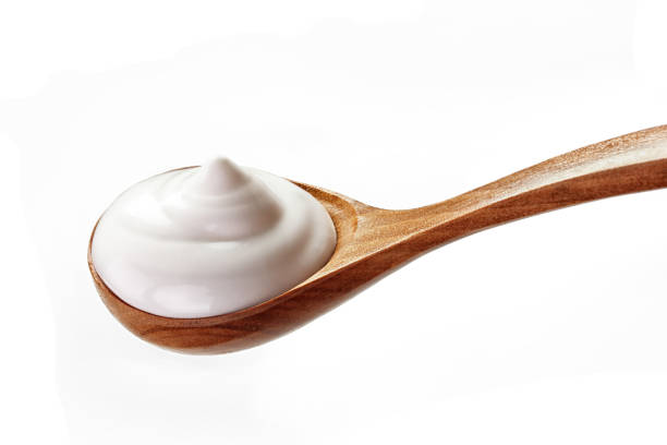 istock cream sour in a spoon isolated white backround 1137697584