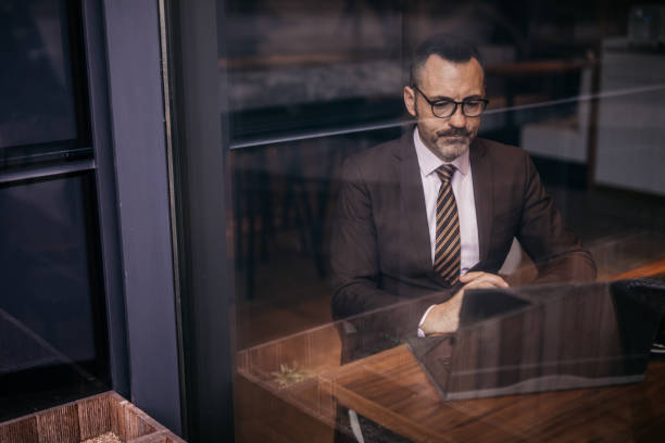 istock Serious senior businessman using laptop 1137701246