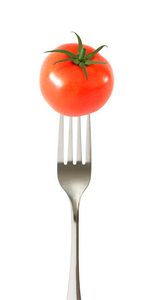 istock Tomato whole one impaled on a fork isolated on white background with clipping path. 1137703396