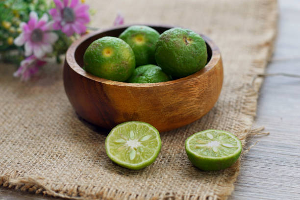 istock fresh lime citrus on wooden bowl with flower background 1137705067