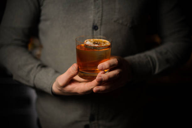 istock Bartender serving a delicious cocktail with a dried orange 1137705372