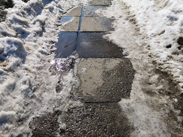 istock Winter melting snow on the road closeup, early spring 1137718208