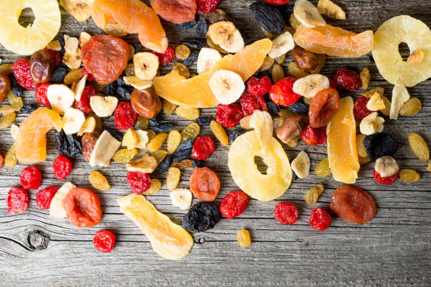 Mix of dried and candied fruit on a wooden background, top view Mix of dried and candied fruit on a wooden background, top view dried fruit stock pictures, royalty-free photos & images