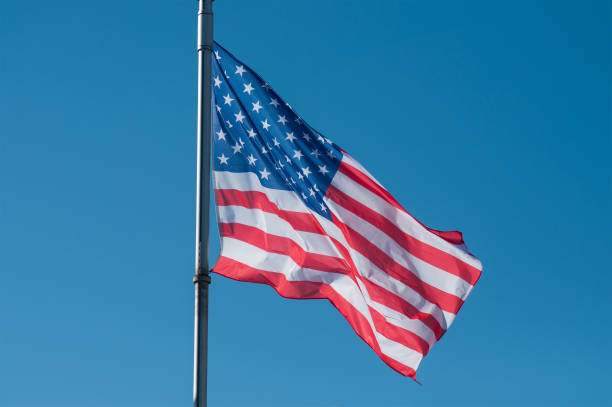 istock american flag on blue sky background 1137724052