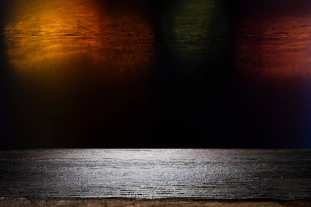 Wooden table with blur night bokeh background.