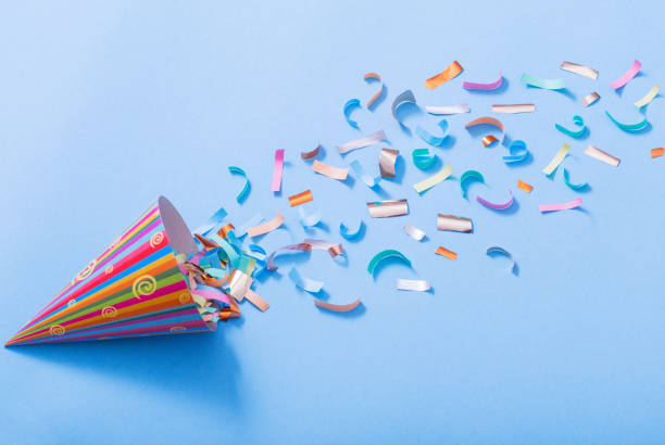 istock birthday hat with confetti on paper background 1137728496