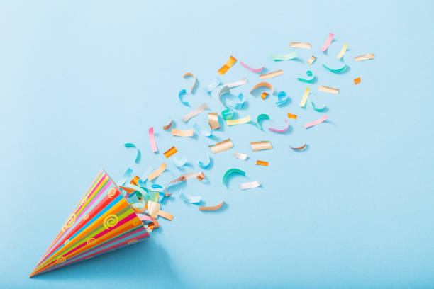 istock birthday hat with confetti on paper background 1137728497