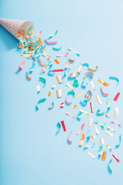 istock birthday hat with confetti on paper background 1137728503