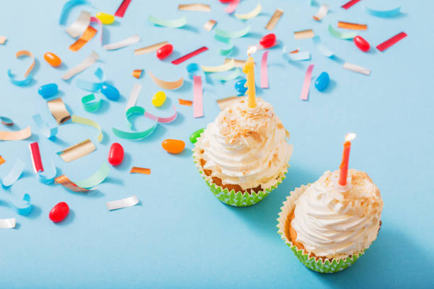istock birthday hat with confetti and cupcake on blue paper background 1137728508