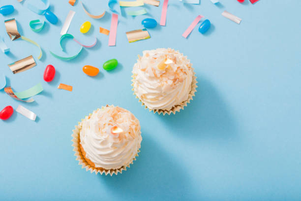 istock birthday hat with confetti and cupcake on blue paper background 1137728509