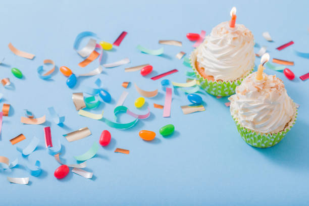 istock birthday hat with confetti and cupcake on blue paper background 1137728516