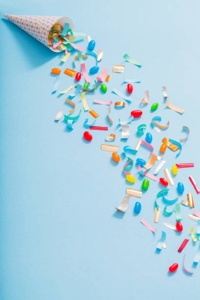 istock birthday hat with confetti on paper background 1137728519
