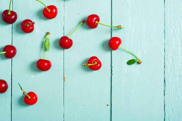 istock Cherry fruits on blue wooden 1137729114