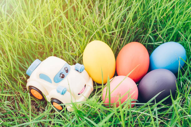 пасхальное яйцо и автомобиль на травяном фоне - easter egg figurine easter holiday стоковые фото и изображения