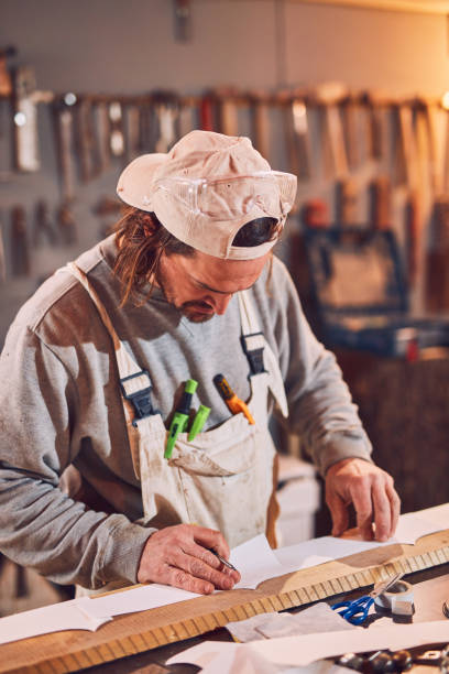 istock Male carpenter working on old wood in a retro vintage workshop. 1137730732
