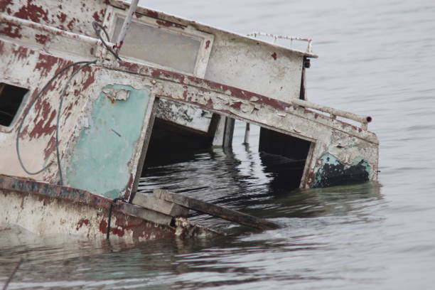 istock Old ruined boat sinking in river water 1137732119