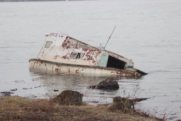 istock Old ruined boat sinking in river water 1137732638