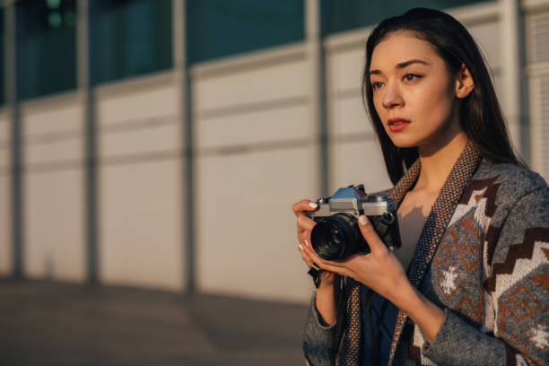 istock Charming young woman with photo camera 1137733663