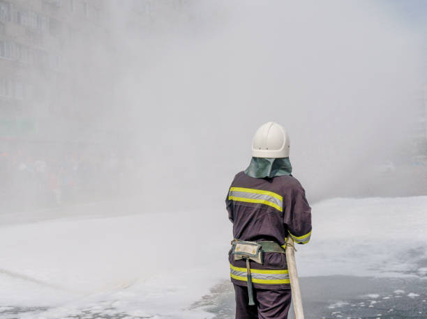 istock Firefighter using foam from hose for fire fighting, Firefighter spraying high pressure foam 1137734556