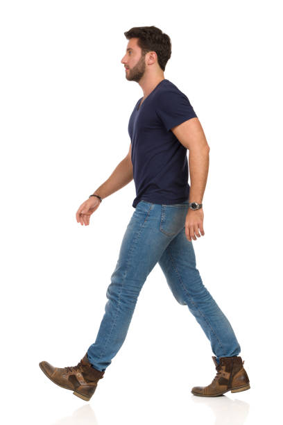 istock Serious Walking Man In Blue T-shirt, Jeans And Boots 1137734752