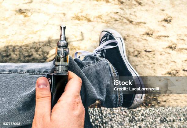 Ecig Addiction Young People Electronic Cigarette Electric Smoker Addiction Vaping Stock Photo - Download Image Now