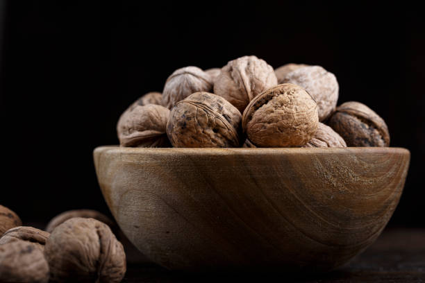 istock inshell whole walnuts on dark wooden background. 1137737151